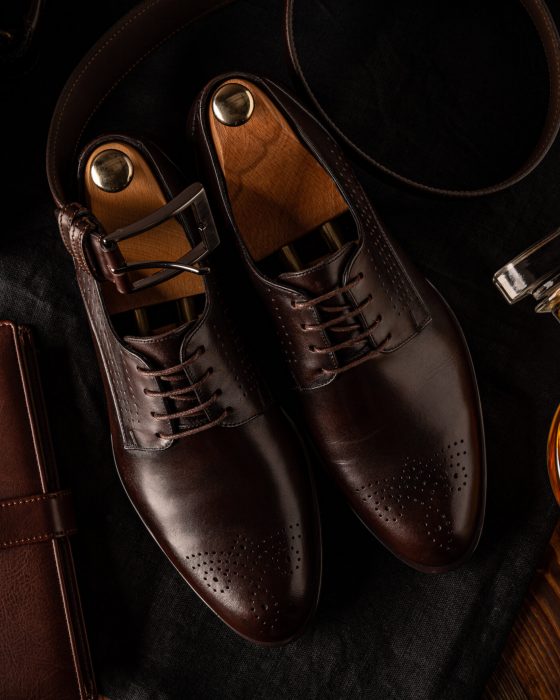 Still life of men fashion. Business look composition with shoes, belt and diary