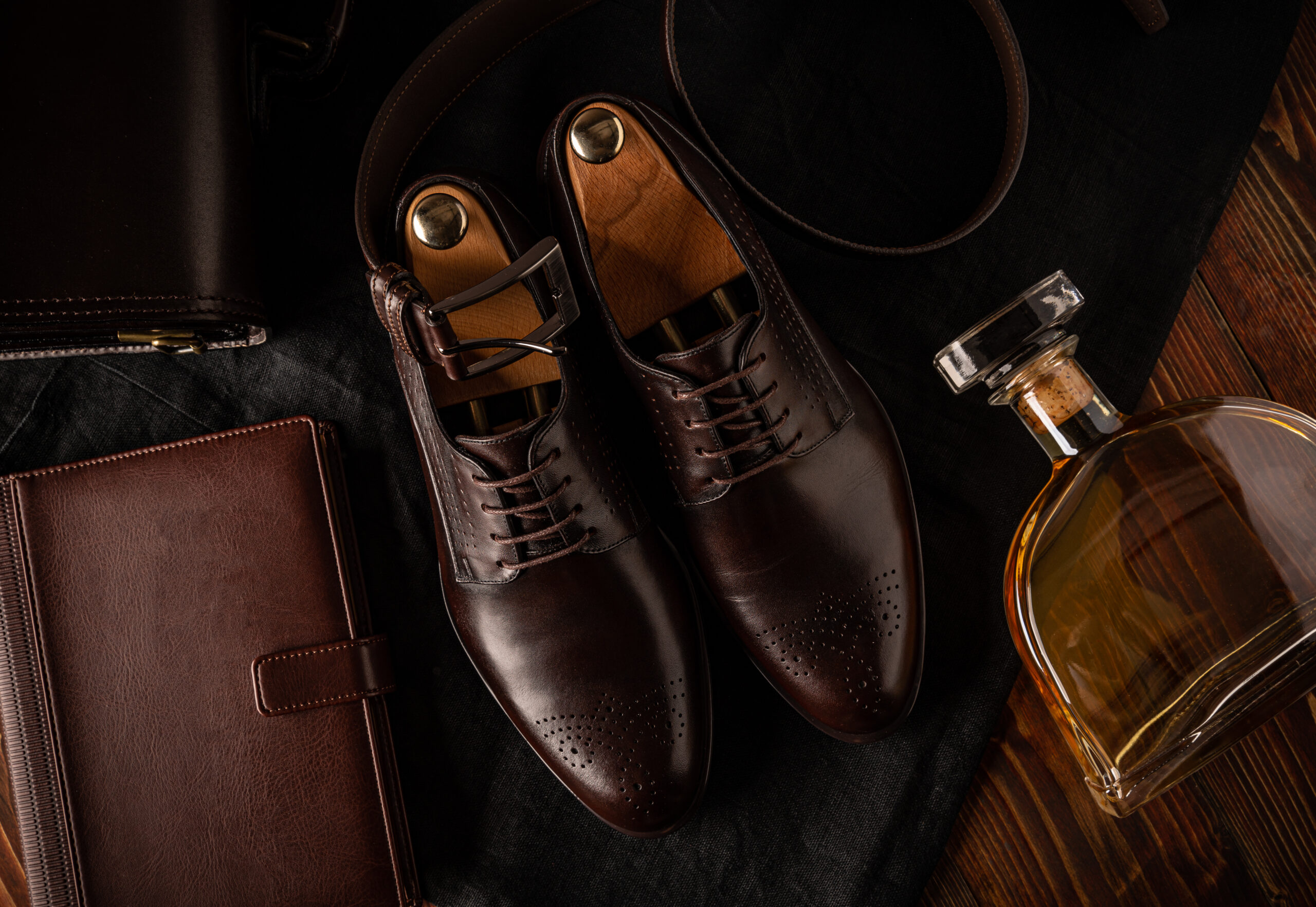 Still life of men fashion. Business look composition with shoes, belt and diary